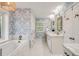 Spacious bathroom with tub, shower, white cabinets, marble counters, and stylish patterned wallpaper at 1018 Layfield Ct, Dunwoody, GA 30338
