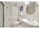 Well-lit bathroom with a pedestal sink, framed mirror, and glass-enclosed shower at 1018 Layfield Ct, Dunwoody, GA 30338
