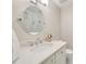 Stylish bathroom featuring an oval mirror, modern lighting, and a white vanity at 1018 Layfield Ct, Dunwoody, GA 30338