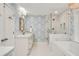 Bathroom features patterned wallpaper, double vanity, marble countertops, and glass-enclosed shower at 1018 Layfield Ct, Dunwoody, GA 30338