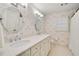 Well-lit bathroom featuring a double vanity, modern lighting, and patterned wallpaper at 1018 Layfield Ct, Dunwoody, GA 30338
