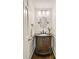 Elegant powder room featuring an ornate vanity, oval mirror, and stylish lighting at 1018 Layfield Ct, Dunwoody, GA 30338