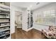 Spacious closet featuring custom shelves, hanging rods, and a view to the living room at 1018 Layfield Ct, Dunwoody, GA 30338