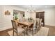 Formal dining room with paneled walls, hardwood floors, chandelier, and stylish furnishings at 1018 Layfield Ct, Dunwoody, GA 30338