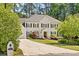 Charming two-story home with a well-kept lawn, mature trees, and a classic white facade at 1018 Layfield Ct, Dunwoody, GA 30338