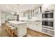 Bright, updated kitchen with white cabinets, stainless steel appliances, and a center island with seating at 1018 Layfield Ct, Dunwoody, GA 30338