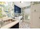 Charming laundry room featuring floral wallpaper, blue cabinets, and stainless steel sink at 1018 Layfield Ct, Dunwoody, GA 30338