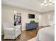 Bedroom with walk-in closet, TV, and ensuite bathroom; furniture includes armchair and dresser at 1018 Layfield Ct, Dunwoody, GA 30338