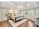 Bright main bedroom with tray ceiling, hardwood floors, and a large window with natural light at 1018 Layfield Ct, Dunwoody, GA 30338