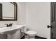 Elegant half-bathroom with modern fixtures and a pedestal sink at 11 Peyton Place Sw, Atlanta, GA 30311