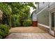 Private backyard featuring a stone patio and gravel area, with a gate for easy access at 1202 Hardee Ne St, Atlanta, GA 30307