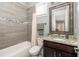 Cozy bathroom with granite countertops, tile floors and bathtub with shower at 1202 Hardee Ne St, Atlanta, GA 30307
