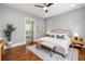 Bedroom with a large bed, ensuite bath, and neutral decor at 1202 Hardee Ne St, Atlanta, GA 30307