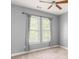 Neutral bedroom with grey walls, neutral carpet, and a ceiling fan at 1202 Hardee Ne St, Atlanta, GA 30307