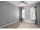 A bedroom with grey walls and neutral carpet and a ceiling fan at 1202 Hardee Ne St, Atlanta, GA 30307