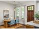 Bright dining room with modern lighting, wooden table with blue chairs, and a decorative rug at 1202 Hardee Ne St, Atlanta, GA 30307