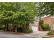 Beautiful home exterior with stone accents, mature trees, and attached garage with long driveway at 1202 Hardee Ne St, Atlanta, GA 30307