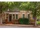 Charming two-story house featuring a brick facade, covered porch, and professionally landscaped front yard at 1202 Hardee Ne St, Atlanta, GA 30307