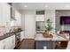 Modern kitchen featuring stainless steel appliances, a kitchen island with granite countertop, and white cabinets at 1202 Hardee Ne St, Atlanta, GA 30307