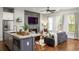 Open-concept living room featuring a fireplace, TV, and a modern kitchen island with barstool seating at 1202 Hardee Ne St, Atlanta, GA 30307