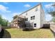 Backyard featuring a well-maintained lawn, trampoline, and a view of the home's exterior with its screened-in porch at 139 Treeline Trl, Canton, GA 30115