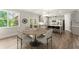 Bright dining area features hardwood floors, with an open view of the kitchen and plenty of natural light at 139 Treeline Trl, Canton, GA 30115