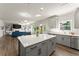 Open kitchen with a center island, stainless steel appliances, and seamless flow into the living room at 139 Treeline Trl, Canton, GA 30115