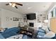 Comfortable living room with a fireplace, built-in bookshelves, and plush blue seating with lots of natural light at 139 Treeline Trl, Canton, GA 30115