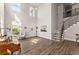 Bright living room features soaring ceilings, a staircase, and lots of natural light from large windows at 139 Treeline Trl, Canton, GA 30115