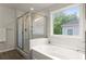 Main bathroom with a soaking tub, separate shower, and ample natural light at 139 Treeline Trl, Canton, GA 30115