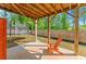 Backyard patio with an orange chair, providing a cozy outdoor space overlooking the green lawn and trees at 139 Treeline Trl, Canton, GA 30115