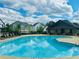 Community pool surrounded by lounge chairs and featuring a covered pavilion, ideal for relaxation at 139 Treeline Trl, Canton, GA 30115