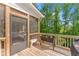 Relaxing screened-in porch with wood floors, offering a peaceful retreat with views of lush greenery at 139 Treeline Trl, Canton, GA 30115