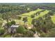 Aerial view of a well-manicured golf course with lush green fairways, mature trees, and luxurious homes at 5650 Buckleigh Pointe, Suwanee, GA 30024