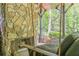 Outdoor back porch featuring a stone fireplace and a comfortable swing for relaxation at 5650 Buckleigh Pointe, Suwanee, GA 30024
