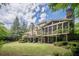 Expansive backyard featuring a well-manicured lawn and a beautiful view of the home's exterior at 5650 Buckleigh Pointe, Suwanee, GA 30024
