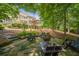 Beautiful backyard sitting area with stone features and comfortable seating surrounding a fire pit at 5650 Buckleigh Pointe, Suwanee, GA 30024
