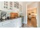 Bar area with a wine rack, beverage fridge, sink, and black countertops at 5650 Buckleigh Pointe, Suwanee, GA 30024