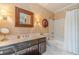 Well-lit bathroom featuring stylish lighting fixtures, a framed mirror, and a shower with a curtain at 5650 Buckleigh Pointe, Suwanee, GA 30024