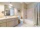 Well-appointed bathroom with a dual-sink vanity, framed mirror, and shower-tub combo for convenience at 5650 Buckleigh Pointe, Suwanee, GA 30024