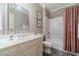 Traditional bathroom with white vanity, mirror and shower at 5650 Buckleigh Pointe, Suwanee, GA 30024