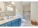 Bright bathroom with a stylish vanity, modern fixtures, and a glass-enclosed shower at 5650 Buckleigh Pointe, Suwanee, GA 30024