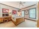 Cozy bedroom featuring striped wallpaper, sports memorabilia, and natural light from two windows at 5650 Buckleigh Pointe, Suwanee, GA 30024