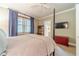 Comfortable bedroom featuring neutral tones, soft curtains, and a cozy ambiance for rest at 5650 Buckleigh Pointe, Suwanee, GA 30024