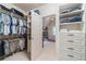 Spacious walk-in closet with ample shelving and storage solutions, creating a tidy and organized space at 5650 Buckleigh Pointe, Suwanee, GA 30024
