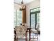 Dining Area with a wood table, upholstered chairs, and a view of the outdoors through large windows at 5650 Buckleigh Pointe, Suwanee, GA 30024