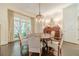 Bright dining room featuring hardwood floors, large windows, and classic decor at 5650 Buckleigh Pointe, Suwanee, GA 30024