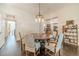 Well-lit dining room with hardwood floors and access to other rooms at 5650 Buckleigh Pointe, Suwanee, GA 30024