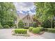 A well-manicured lawn and landscaping surround this lovely home with a circular driveway at 5650 Buckleigh Pointe, Suwanee, GA 30024