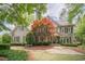 Charming two-story home with beautiful landscaping and an inviting covered front porch at 5650 Buckleigh Pointe, Suwanee, GA 30024